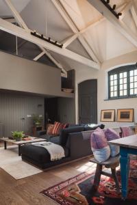a living room with a couch and a table at Exe Valley Barn in Exeter