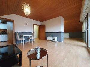 a living room with a table and a dining room at Wohnung mit Ausblick in Tauberbischofsheim in Tauberbischofsheim