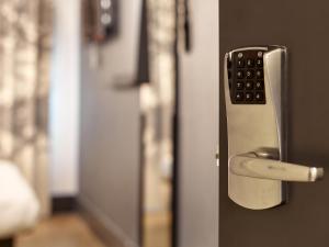 a remote control sticking out of a door at B&B HOTEL Strasbourg Nord Artisans in Vendenheim +16 photos