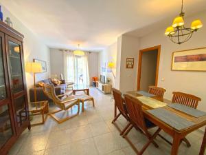 a living room with a dining room table and chairs at Apartment with terrace and sea view at Parque Atalaya, Conil, Atalaya Mar in Conil de la Frontera