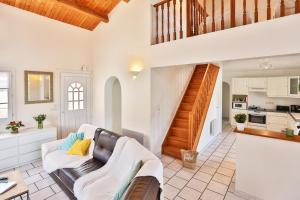 a living room with a couch and a staircase at Camping Le Petit Rocher in Longeville-sur-Mer