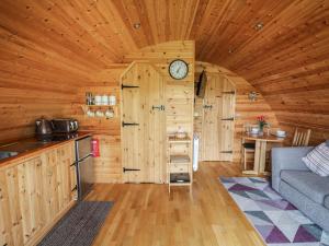 a kitchen and living room in a log cabin at Pine Lodge in Llangadog