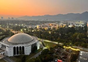 a building with a dome on top of it at sunset at One Constitution Avenue - Apartments by Superhost in Islamabad