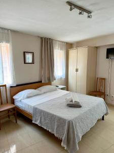 a bedroom with a bed with a towel on it at Royal Inn Aparthotel in Lloret de Mar