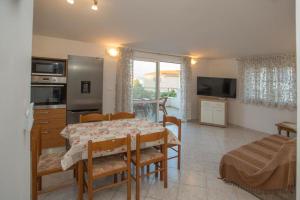 a kitchen and dining room with a table and chairs at Serenity near the sea in Okrug Gornji