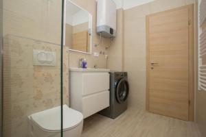 a bathroom with a toilet and a washing machine at Serenity near the sea in Okrug Gornji +20 photos