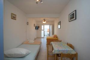 a room with two beds and a table at Serenity near the sea in Okrug Gornji