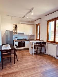 a kitchen with a table and chairs in a room at Jo's House in Calambrone