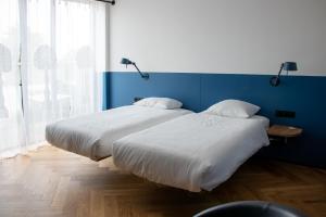Postel nebo postele na pokoji v ubytování De 6 Linden Boutique Hotel
