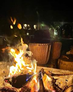 a fire is burning in a pizza oven at Merzouga dreams Camp in Erfoud