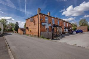 an old brick building on the side of a street at Angel Inn Misson in Misson