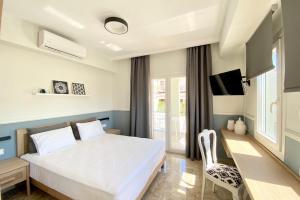 A bed or beds in a room at Mageiras Boutique Hotel