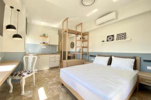 A bed or beds in a room at Mageiras Boutique Hotel