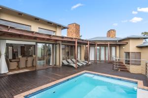a house with a swimming pool on a deck at Elements Private Golf Reserve House 197 in Bela-Bela