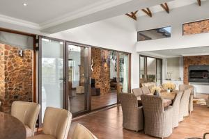 a dining room with a table and chairs at Elements Private Golf Reserve House 197 in Bela-Bela