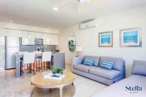 a living room with a couch and a table at A-Nah Apartments, Rooftop Pool, walking distance to 5th avenue in Playa del Carmen