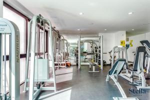 a gym with several tread machines and mirrors at A-Nah Apartments, Rooftop Pool, walking distance to 5th avenue in Playa del Carmen