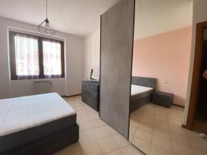 a bedroom with a bed and a large mirror at La Mansardina Casa Fiore in Omegna