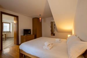 Posteľ alebo postele v izbe v ubytovaní Inn Aosta Apartments