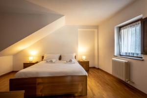 Posteľ alebo postele v izbe v ubytovaní Inn Aosta Apartments