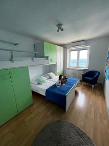 a small room with a bed and a chair at Dolce vita Apartment in Senj