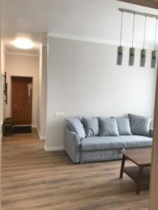a living room with a couch and a table at Vytauto Septyni in Zarasai