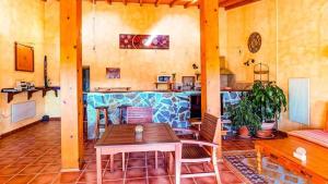 a dining room with a table and a bar at Casa Presente Guesthouse in Carrapateira +37 photos