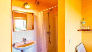 a bathroom with a sink and a shower at Casa Presente Guesthouse in Carrapateira