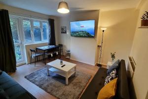 a living room with a couch and a table at 2 Bedroom apartment in Kennington London in London