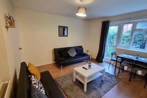 a living room with a couch and a table at 2 Bedroom apartment in Kennington London in London