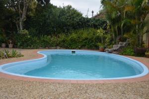 a pool in a yard with a brick border around it at Nowra Motor Inn in Nowra