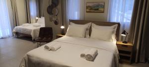 a hotel room with a bed with towels on it at Cruzeto in Syvota