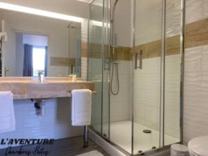 a bathroom with a shower and a sink at l'Aventure in Morcenx