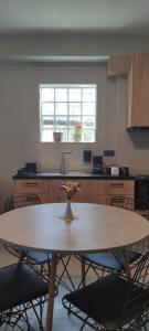 a kitchen with a table with a vase of flowers on it at Cruzeto in Syvota