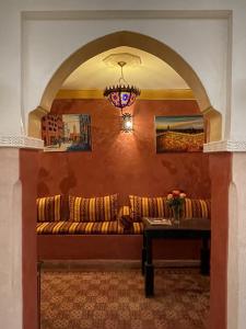 a living room with a couch and a table at Riad M'boja "Chez Ali Baba" in Marrakesh