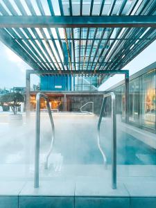 a swimming pool in a building with two metal bars at Sankt Jörgen Park in Gothenburg