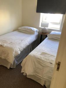 two beds in a room with a window at Shannon Oasis in Carrick on Shannon