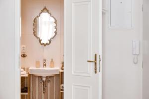 a bathroom with a sink and a mirror at Apartments With The Lions in Prague