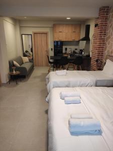 a hotel room with three beds with towels on them at Cruzeto in Syvota