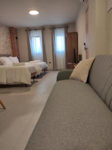 a living room with two beds and a couch at Cruzeto in Syvota