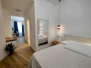 a bedroom with a large bed and a mirror at AquaMar Bed and Breakfast in Crotone