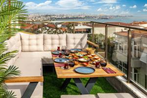 a table with plates of food on a balcony at Monnas Suite in Istanbul