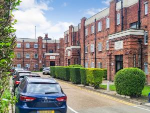a car parked in front of a brick building at 2BR Hendon Flat - Free Parking & Bus stop outside in Hendon
