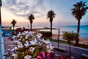 a view of a beach with palm trees and flowers at AquaMar Bed and Breakfast in Crotone