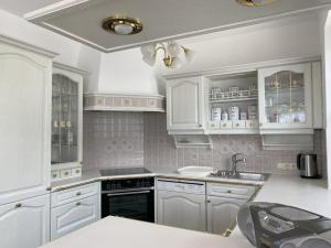 a kitchen with white cabinets and a sink at Au 10 in St. Wolfgang