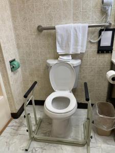 a bathroom with a toilet with a towel rack at Belmont Motel in Skowhegan