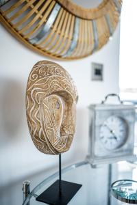a mask on a stand next to a clock at Luxurious 2-Bedroom Penthouse Apartment with Stunning Glass-Wall Views in Barnsley Town Centre in Barnsley
