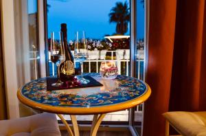 a table with a bottle and glasses on it at AquaMar Bed and Breakfast in Crotone
