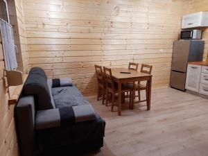 a living room with a table and a couch and a kitchen at Morskie Sarbinowo in Sarbinowo +30 photos