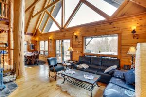 a living room with a couch and a table at Massachusetts Vacation Rental with Deck and Grill in Cheshire